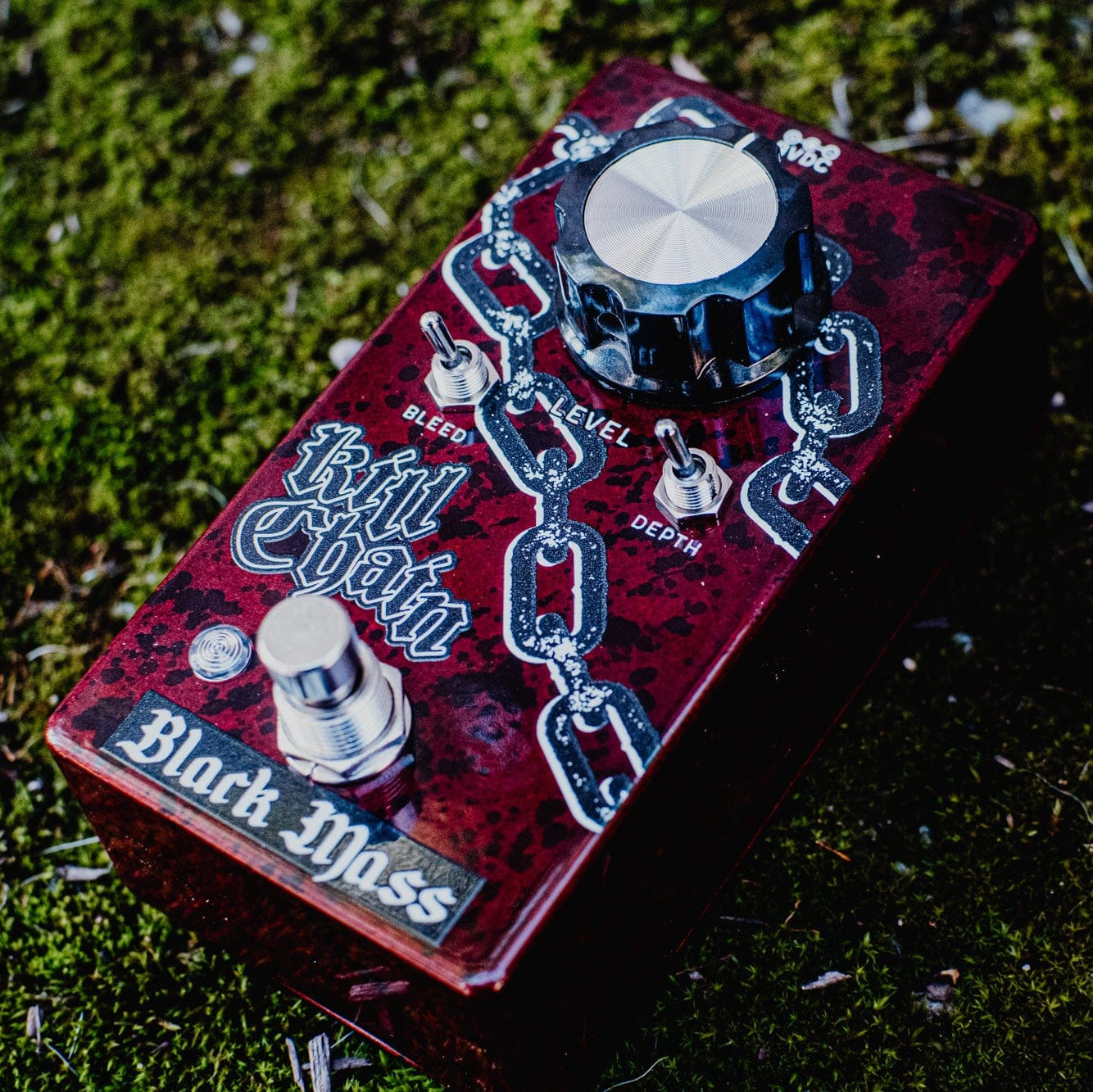 Effect pedal with 'Black Mass' branding on a grassy background